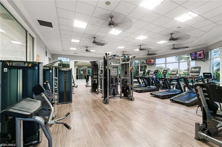 Workout area with a paneled ceiling and ornamental molding