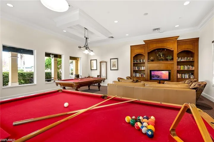 Recreation room featuring pool table, carpet flooring, recessed lighting, ornamental molding, and a large fireplace