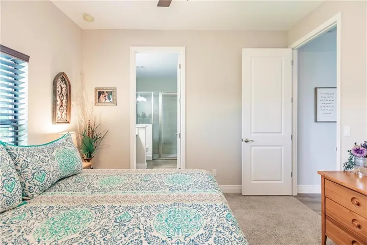In law suite Carpeted bedroom featuring connected bathroom and ceiling fan
