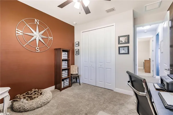 Guest bedroom/Office space featuring carpet and ceiling fan