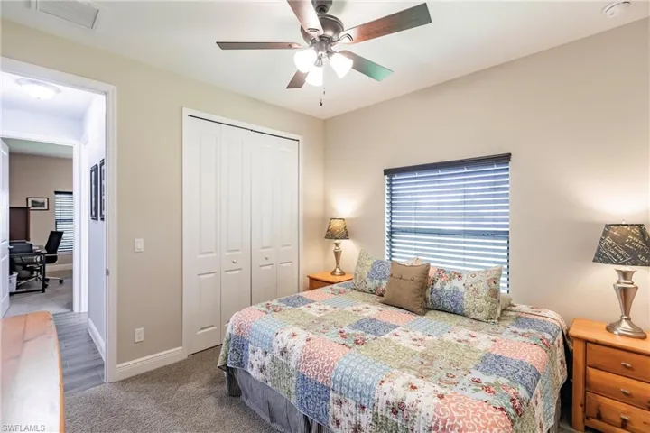 Guest bedroom Carpeted bedroom featuring a closet and ceiling fan