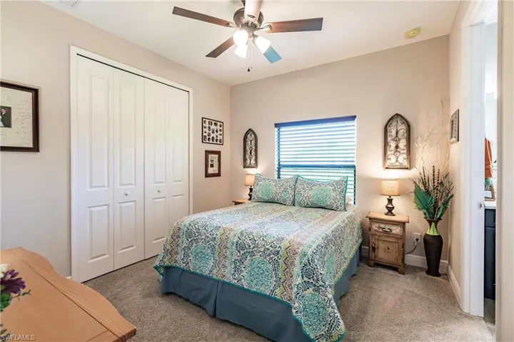 In law suite bedroom Carpeted bedroom featuring ceiling fan and a closet