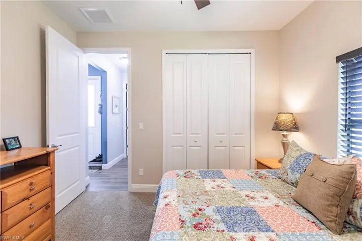 guest bedroom Carpeted bedroom with a closet and ceiling fan
