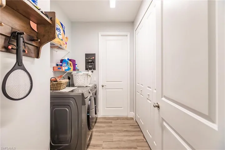 Laundry area with plank tile floors and separate washer and dryer