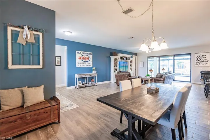 Dining area featuring plank tile flooring and an inviting chandelier