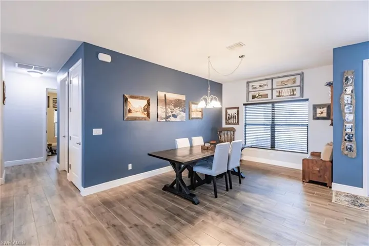 Dining space featuring a chandelier and plank tile flooring