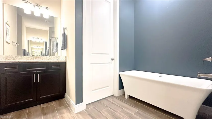 Bathroom with hardwood / wood-style floors and vanity