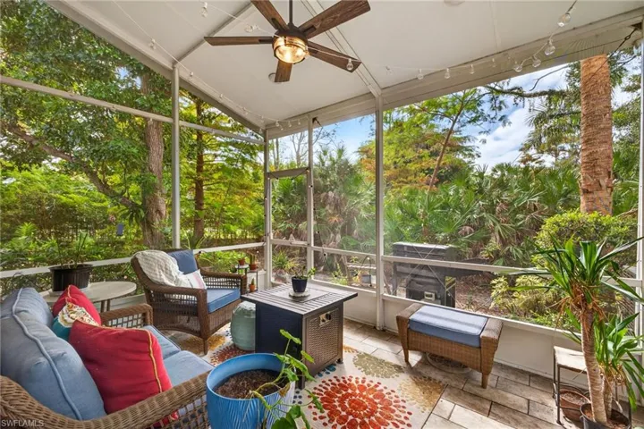 Sunroom with lofted ceiling, ceiling fan, an outdoor living space, and plenty of natural light