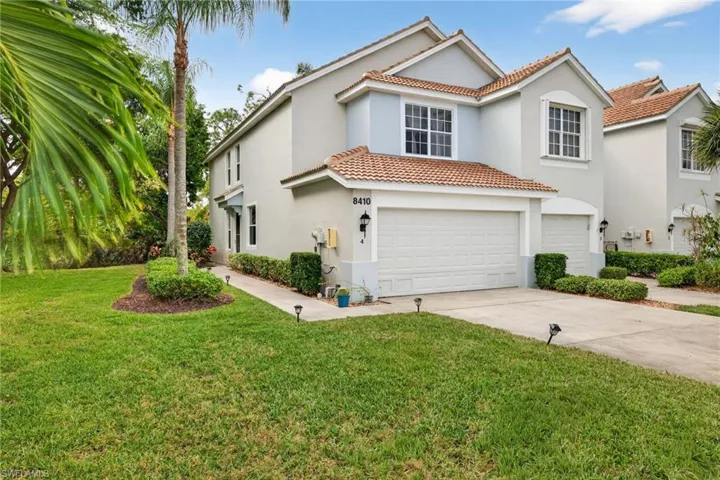 Mediterranean / spanish home featuring a tiled roof, stucco siding, driveway, and an attached garage