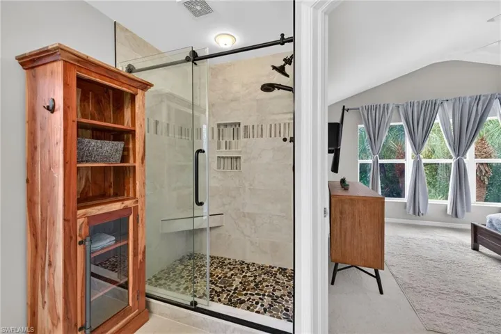Full bathroom featuring vaulted ceiling, a stall shower, a sauna / steam room, and light carpet
