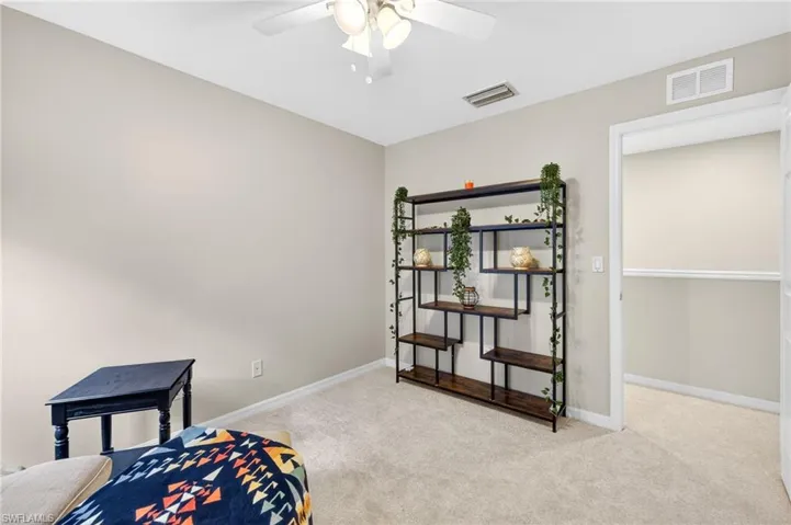 Sitting room featuring light colored carpet and baseboards