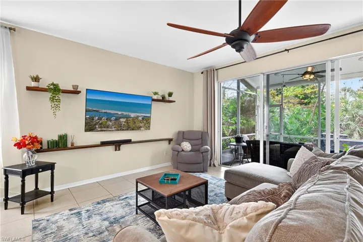 Living area with ceiling fan and light tile patterned floors
