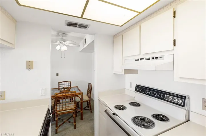 KITCHEN WITH AMPLE CABINETS AND COUNTERS