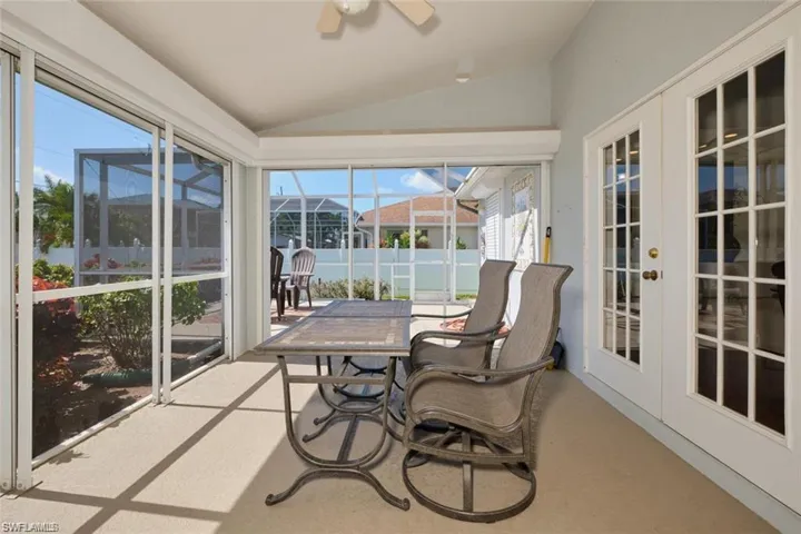 Sunroom with a wealth of natural light, french doors, and ceiling fan