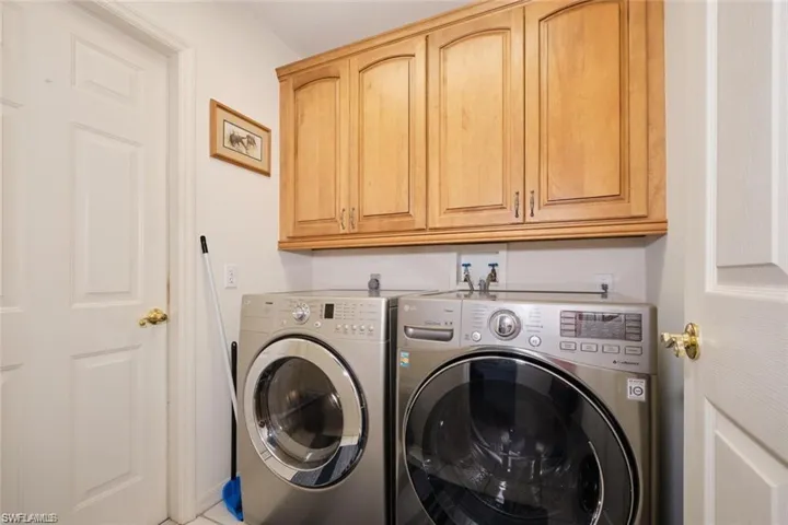Clothes washing area with separate washer and dryer and cabinet space