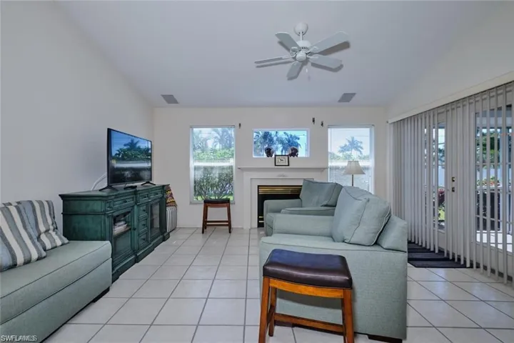 Living room with visible vents, a wealth of natural light, and vaulted ceiling