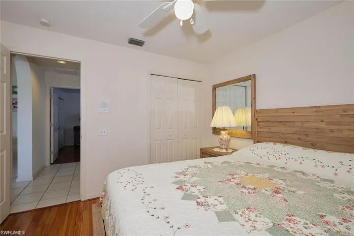 Bedroom with visible vents, a closet, a ceiling fan, and wood finished floors
