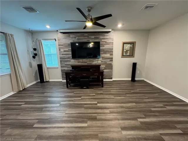 Great room with TV and projection screen.