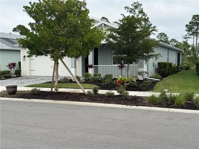 View of front of house and landscaping.