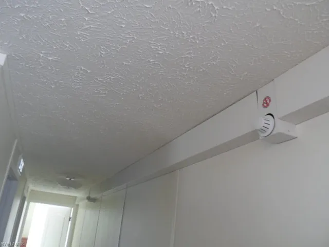 Interior details featuring a textured ceiling and sprinkler system