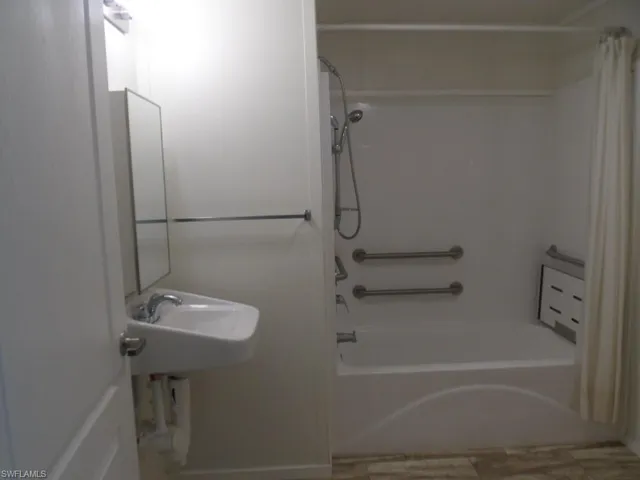 Full bathroom with shower / bath combination with curtain