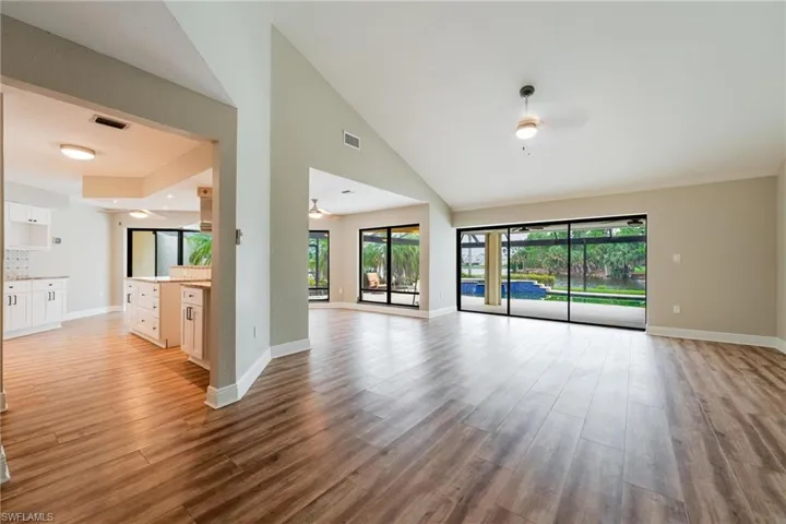 Unfurnished room with light wood-type flooring, a wealth of natural light, and ceiling fan