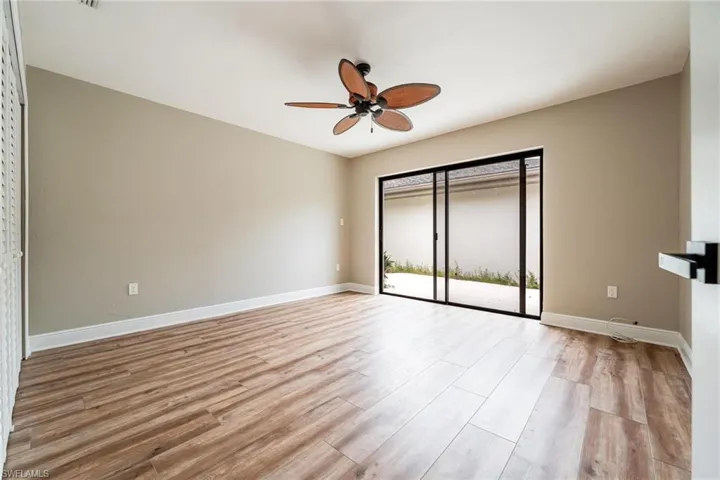 Unfurnished bedroom featuring light wood-type flooring, ceiling fan, and access to exterior