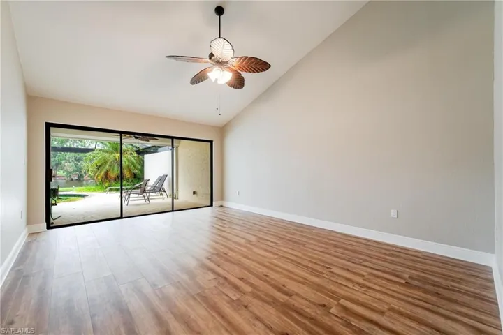 Unfurnished room with high vaulted ceiling, ceiling fan, and light hardwood / wood-style flooring