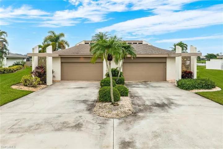View of front of house with a front yard and a garage