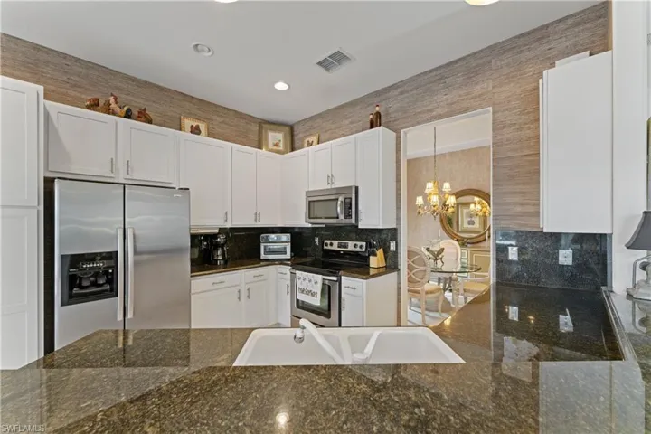 Beautiful kitchen featuring granite countertops and premium stainless steel appliances for a modern and functional cooking space.
