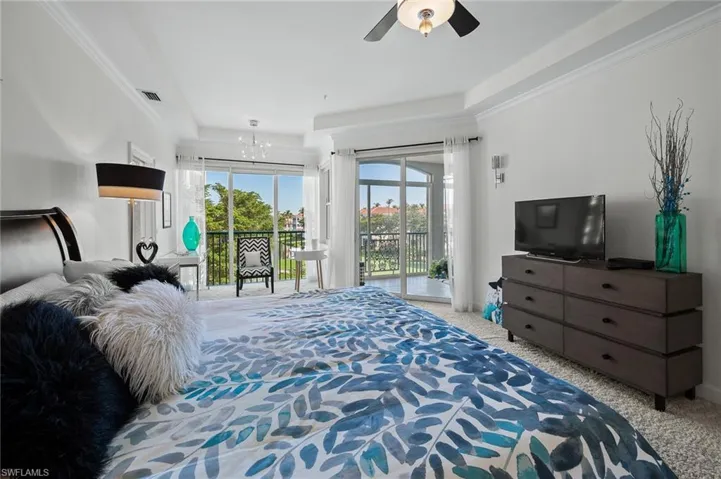 Bedroom with access to exterior, carpet, ornamental molding, ceiling fan, and hanging lights
