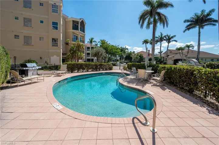 Community pool featuring a patio area and grilling area