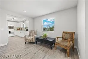 Sitting room with light wood finished floors and baseboards