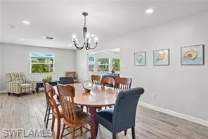 Dining room featuring a chandelier, light wood-type flooring, and recessed lighting