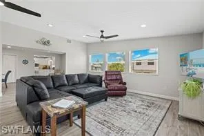 Living room featuring ceiling fan, wood finished floors, and recessed lighting