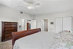 Bedroom featuring a closet, a ceiling fan, and ensuite bathroom