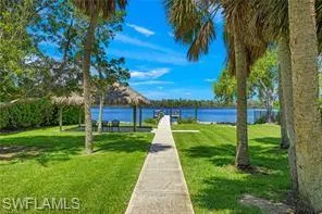 View of community with a water view and a yard