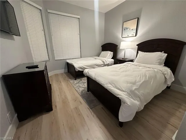 Bedroom with baseboards and light wood-style floors