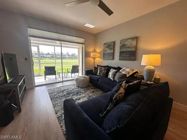 Living room featuring wood finished floors and ceiling fan