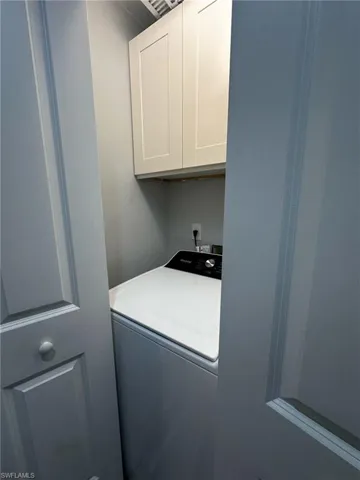 Laundry area featuring cabinet space and washer / clothes dryer