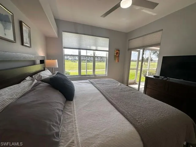 Bedroom featuring access to exterior and ceiling fan