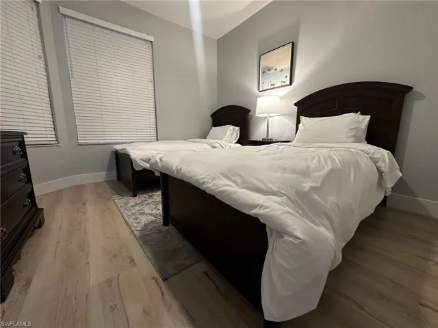 Bedroom featuring light wood finished floors and baseboards