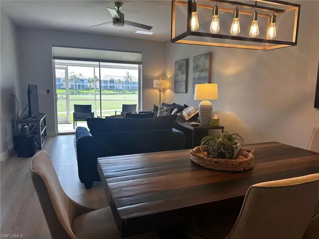 Dining area featuring a ceiling fan and light wood-style flooring