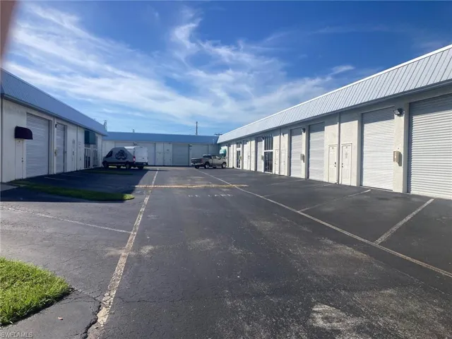 View of parking / parking lot with community garages