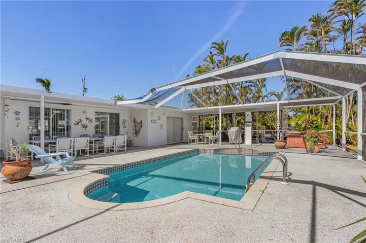 View of swimming pool featuring a patio area and a hot tub