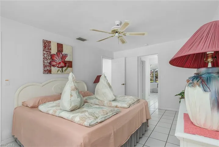 Tiled bedroom with ceiling fan