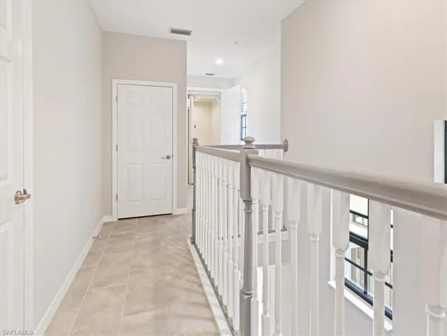 Corridor featuring light tile floors.  Private elevator at the end of hallway.