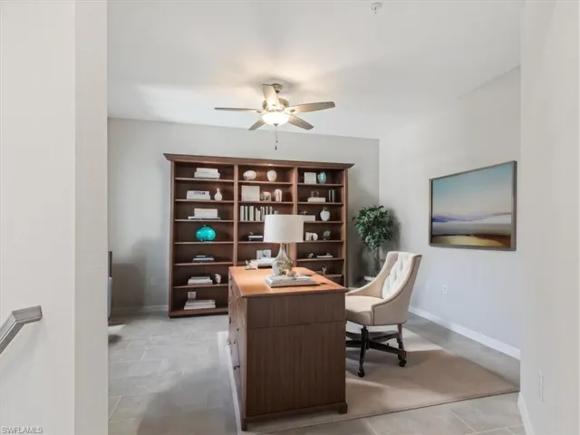 Tiled office featuring ceiling fan virtually staged