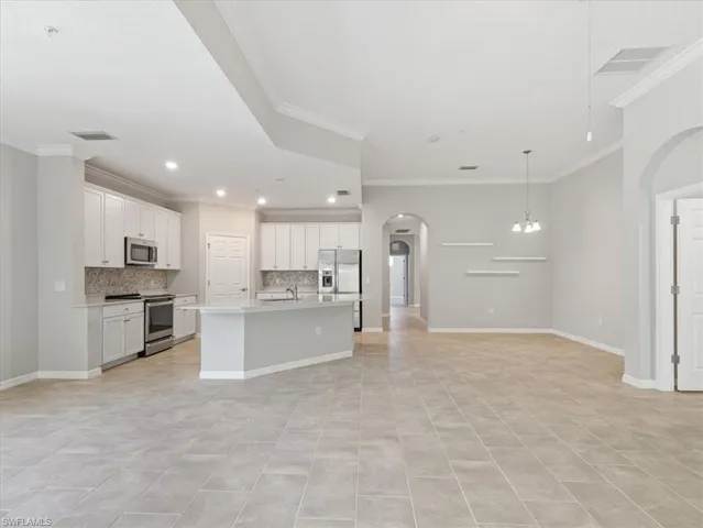 Kitchen with new Bosch dishwasher and GE stove with induction cooktop and air fryer oven.  Dining area decorative shelving