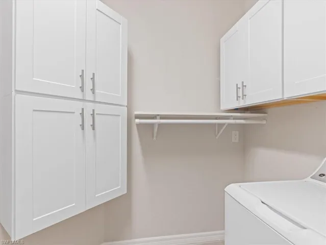 Laundry room featuring cabinets and washer / clothes dryer